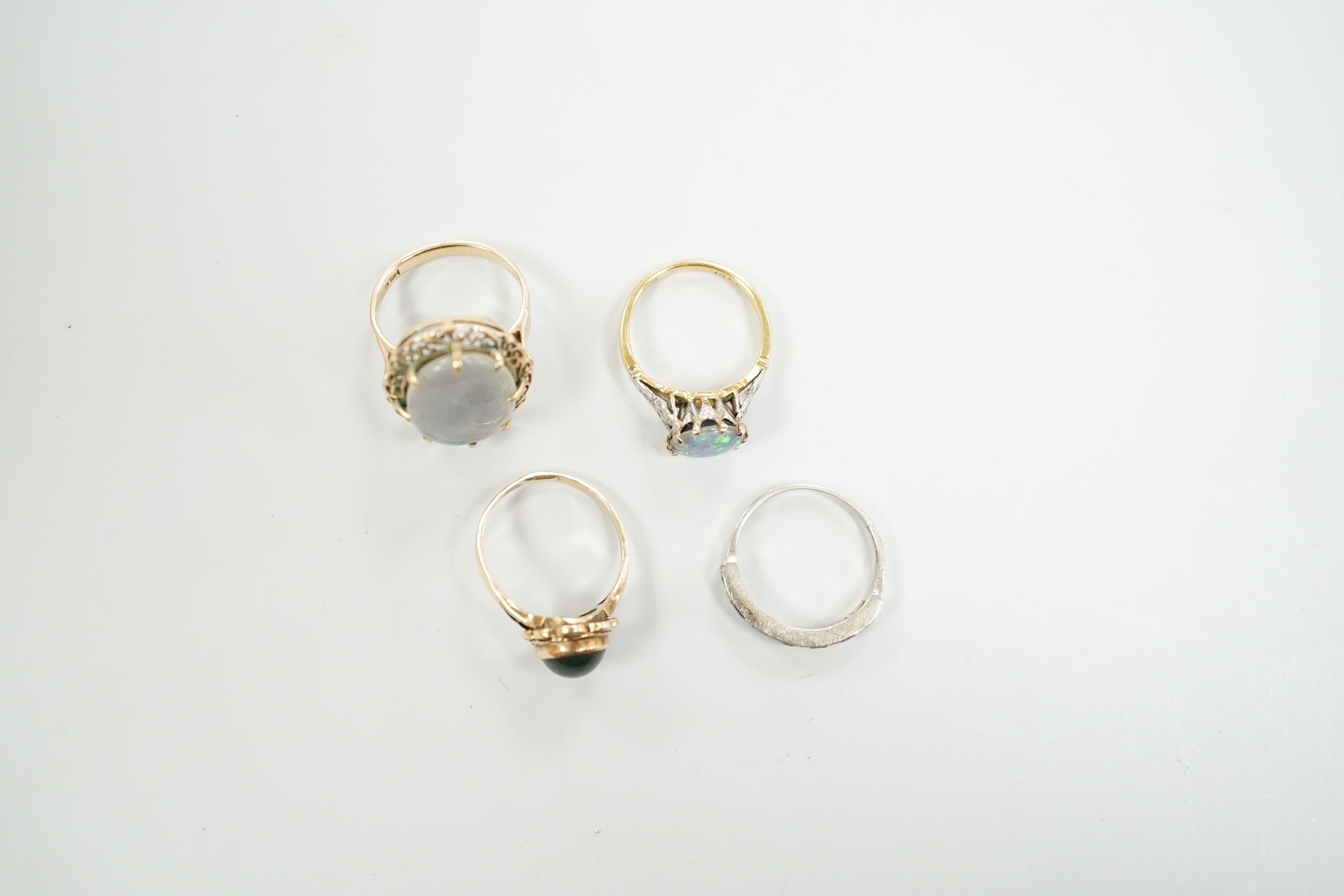 A 1940's 18ct and black opal doublet set dress ring, with diamond chip set shoulders, size L, a 14c and oval doublet ring and two other 9ct and gem set rings.
